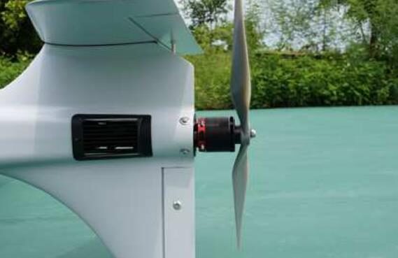 Close-up of the rear pusher motor and propeller behind the tail fin